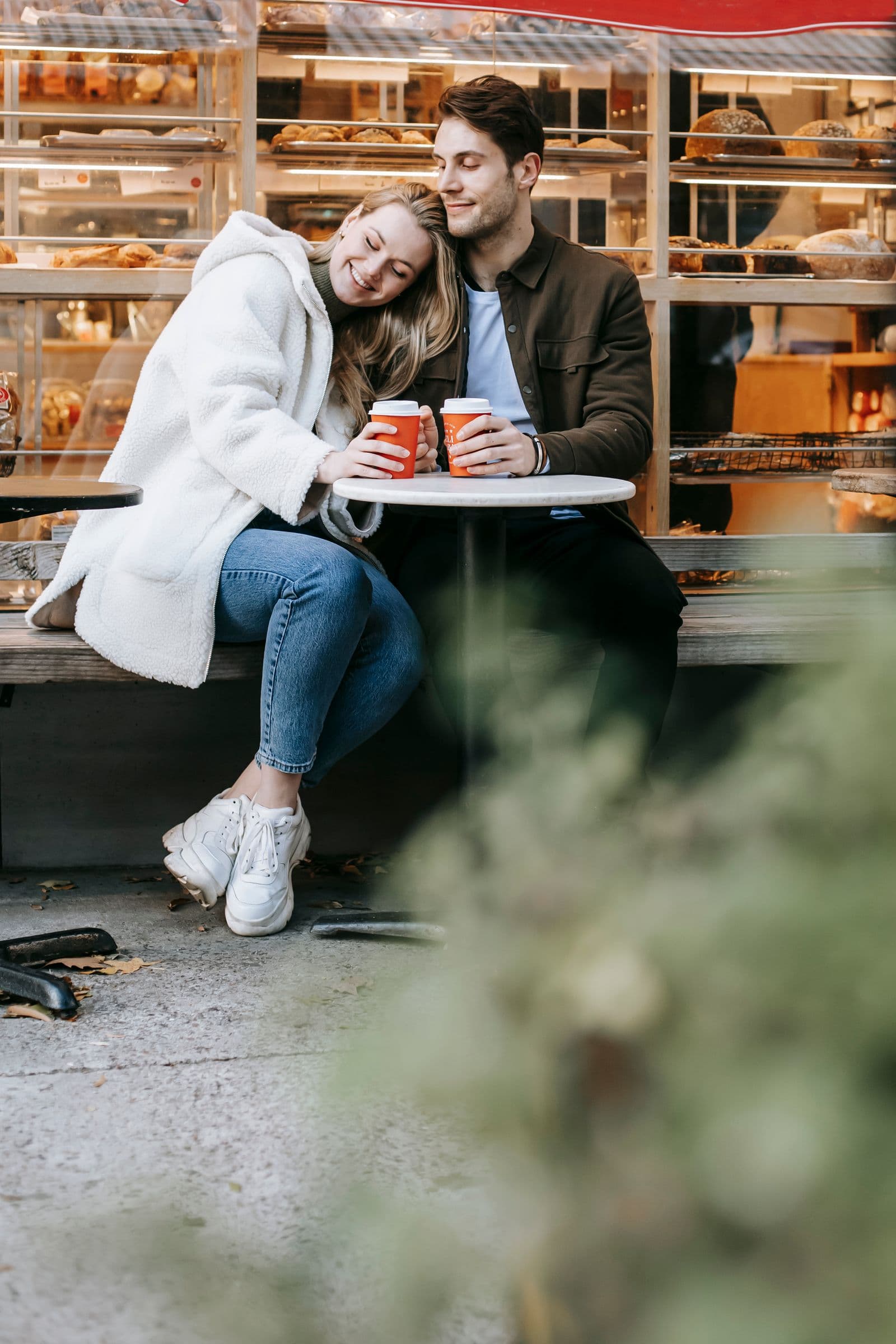 Two adults sharing coffee at an outdoor café